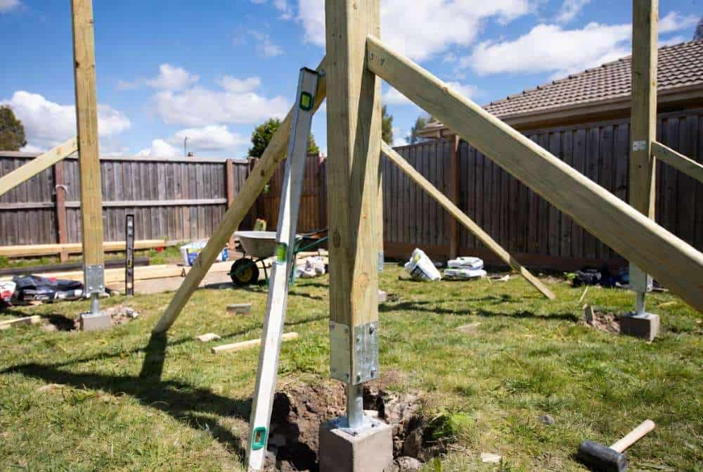 Treated pine posts set in concrete footings with stirrups for DIY gazebo foundation Australia