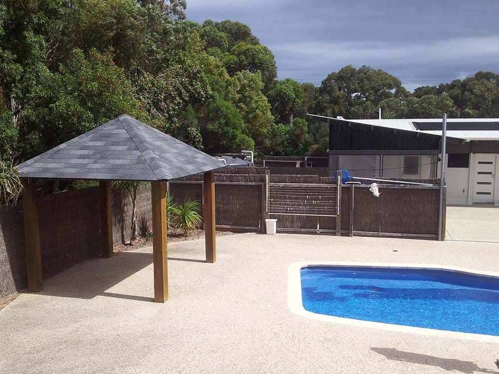 Outdoor Gazebos Australia 26 Poolside wooden gazebo with grey shingle roof next to swimming pool in melbourne backyard